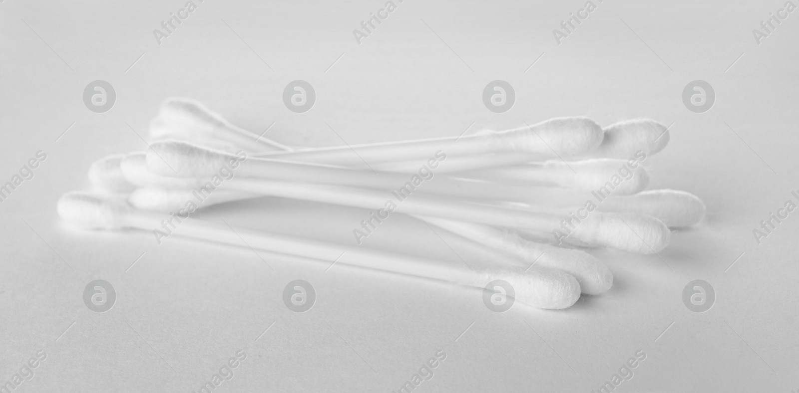 Photo of Heap of clean cotton buds on white background