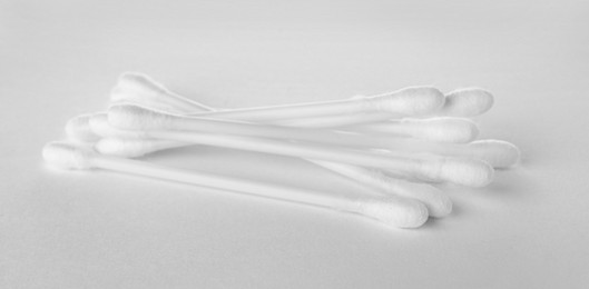 Photo of Heap of clean cotton buds on white background