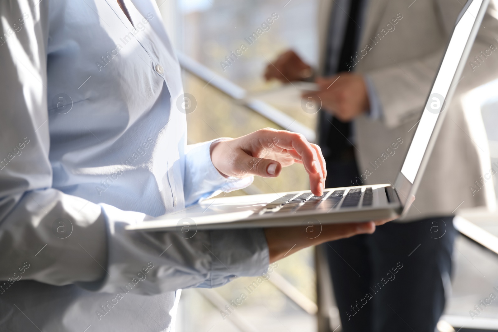 Photo of Businesswoman working with modern laptop in office, closeup