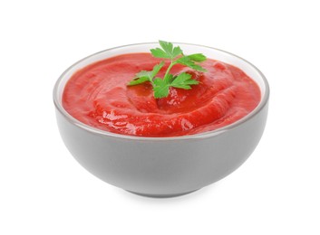 Photo of Organic ketchup and parsley in bowl isolated on white. Tomato sauce