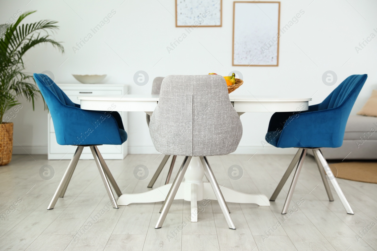 Photo of Stylish room interior with dining table and chairs