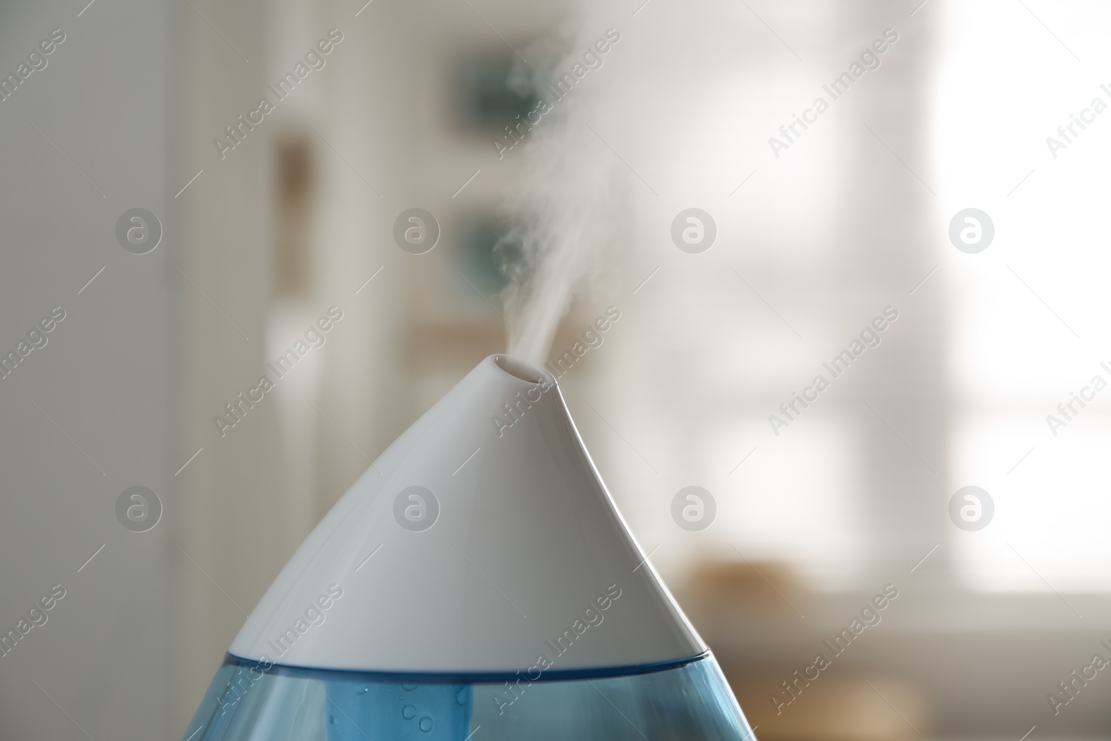 Photo of Modern humidifier indoors, closeup view. Home appliance