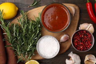 Photo of Fresh marinade and ingredients on wooden table, flat lay