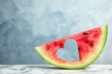 Photo of Slice of watermelon on table against color background