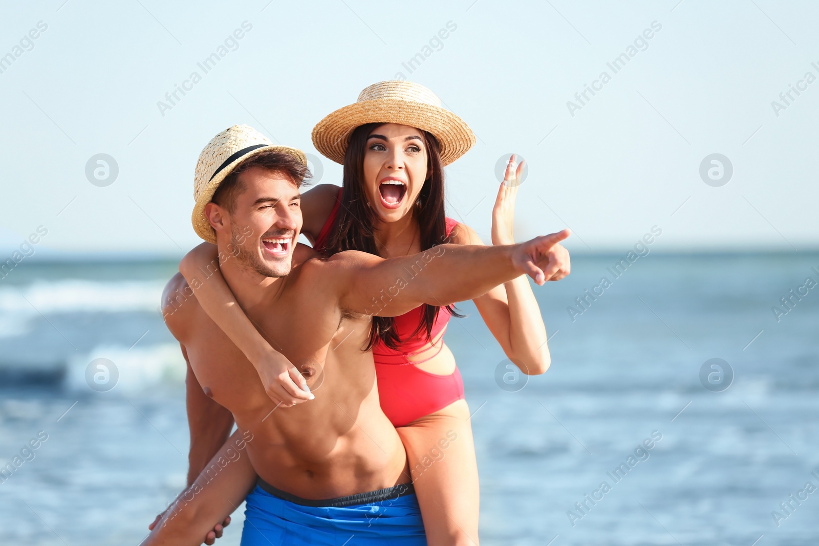 Photo of Happy young couple having fun at beach on sunny day