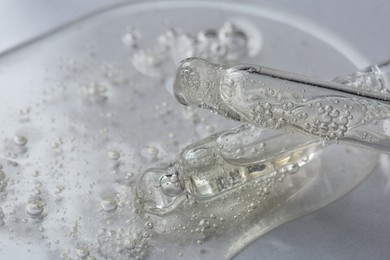 Pipettes with cosmetic serum on white background, macro view. Space for text