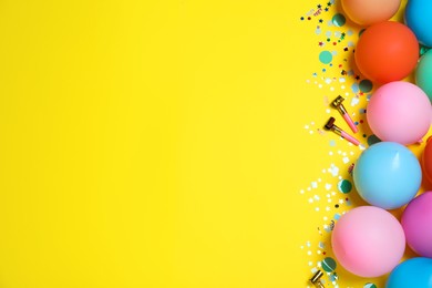 Photo of Flat lay composition with balloons and confetti on yellow background, space for text. Birthday decor