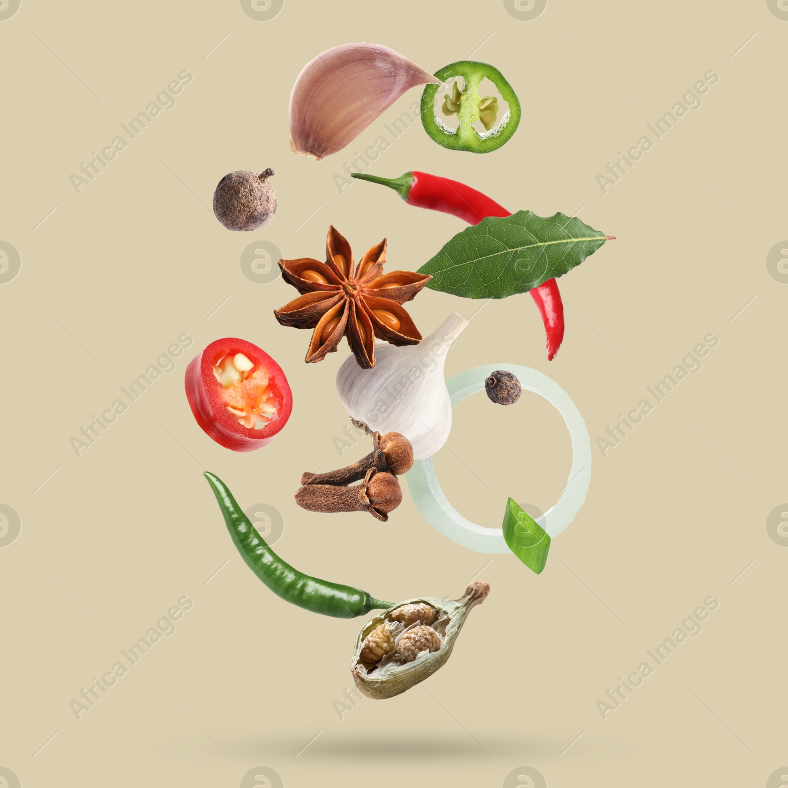 Image of Different spices falling on dark beige background