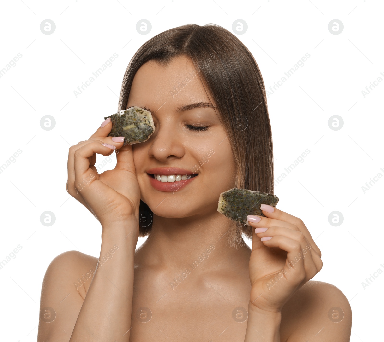 Photo of Young woman with tea bags on white background. Eye skin care