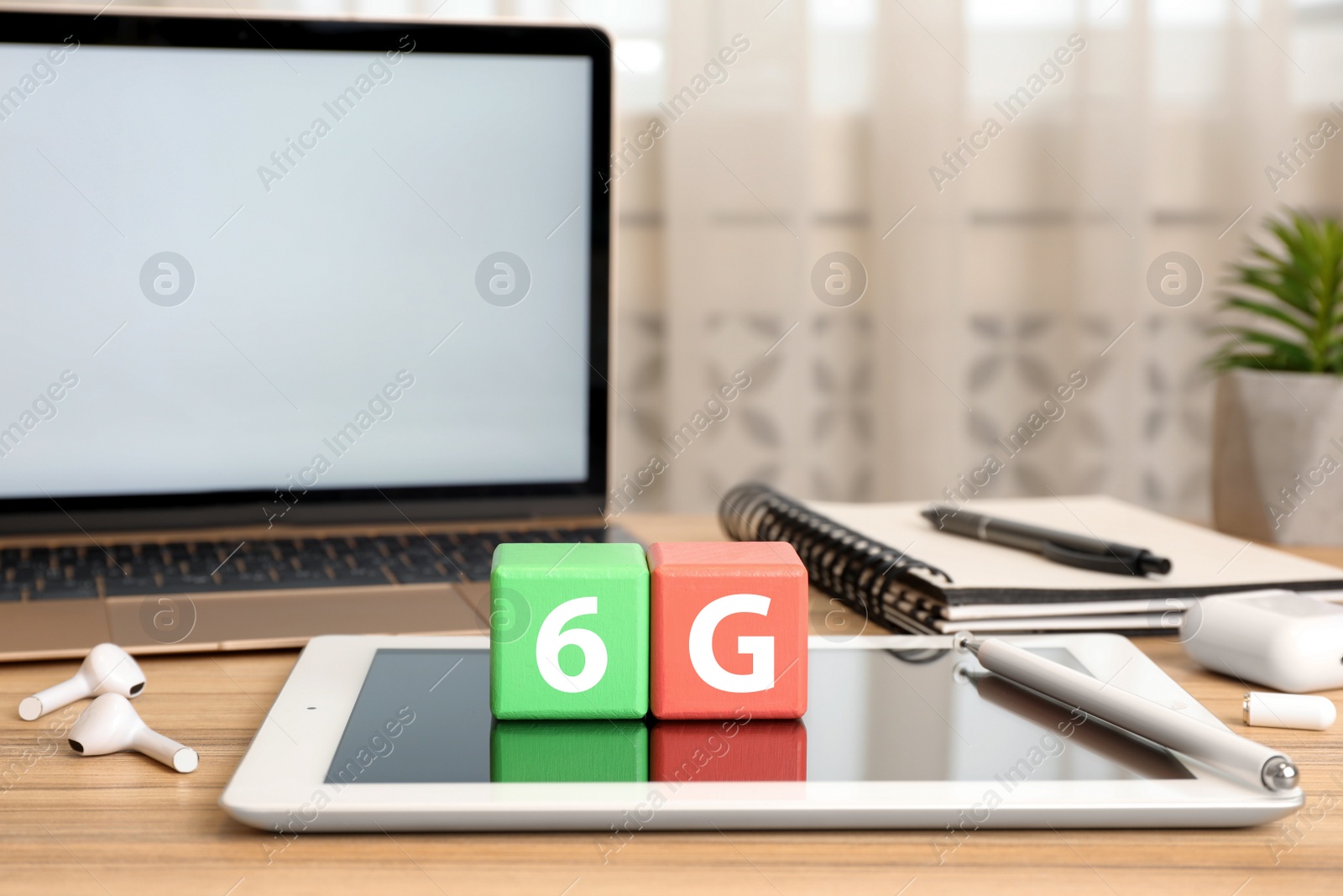 Photo of 6G technology, Internet concept. Color cubes with number, letter and devices on wooden table indoors