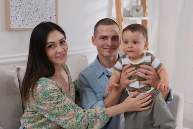 Photo of Portrait of happy family with little child at home