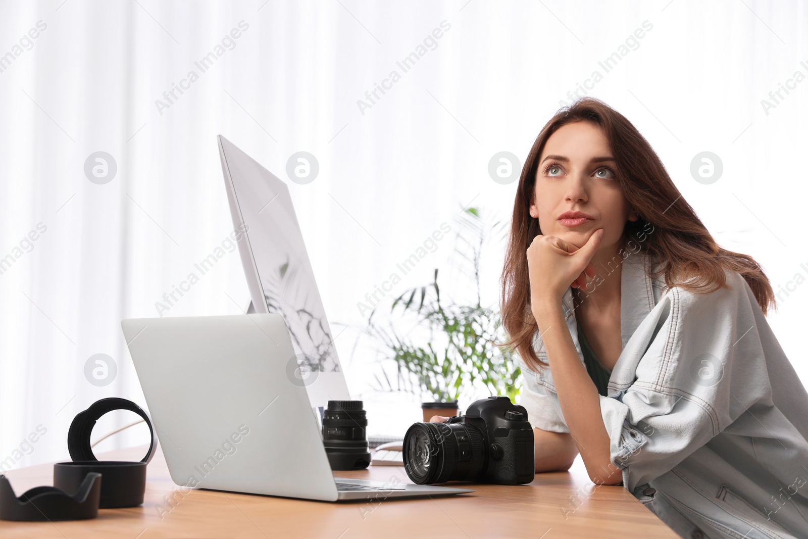 Photo of Professional photographer working at table in office