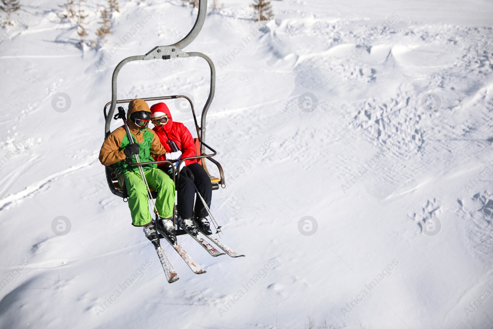 Photo of People using chairlift at mountain ski resort, space for text. Winter vacation