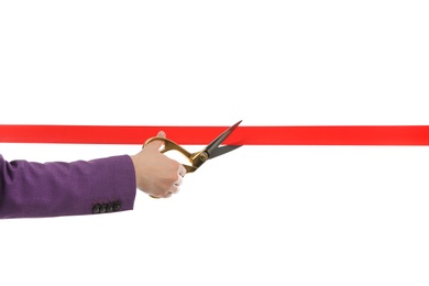 Photo of Woman in office suit cutting red ribbon isolated on white, closeup