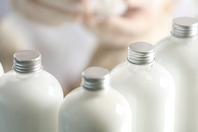 Bottles with cosmetic products in laboratory, closeup
