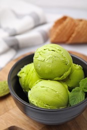 Photo of Tasty matcha ice cream in bowl on table