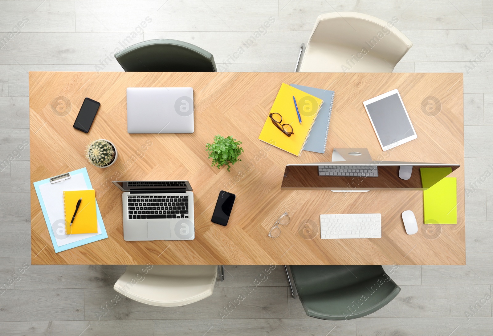 Photo of Modern office table with devices and chairs, top view