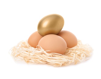 Golden egg among others in nest on white background