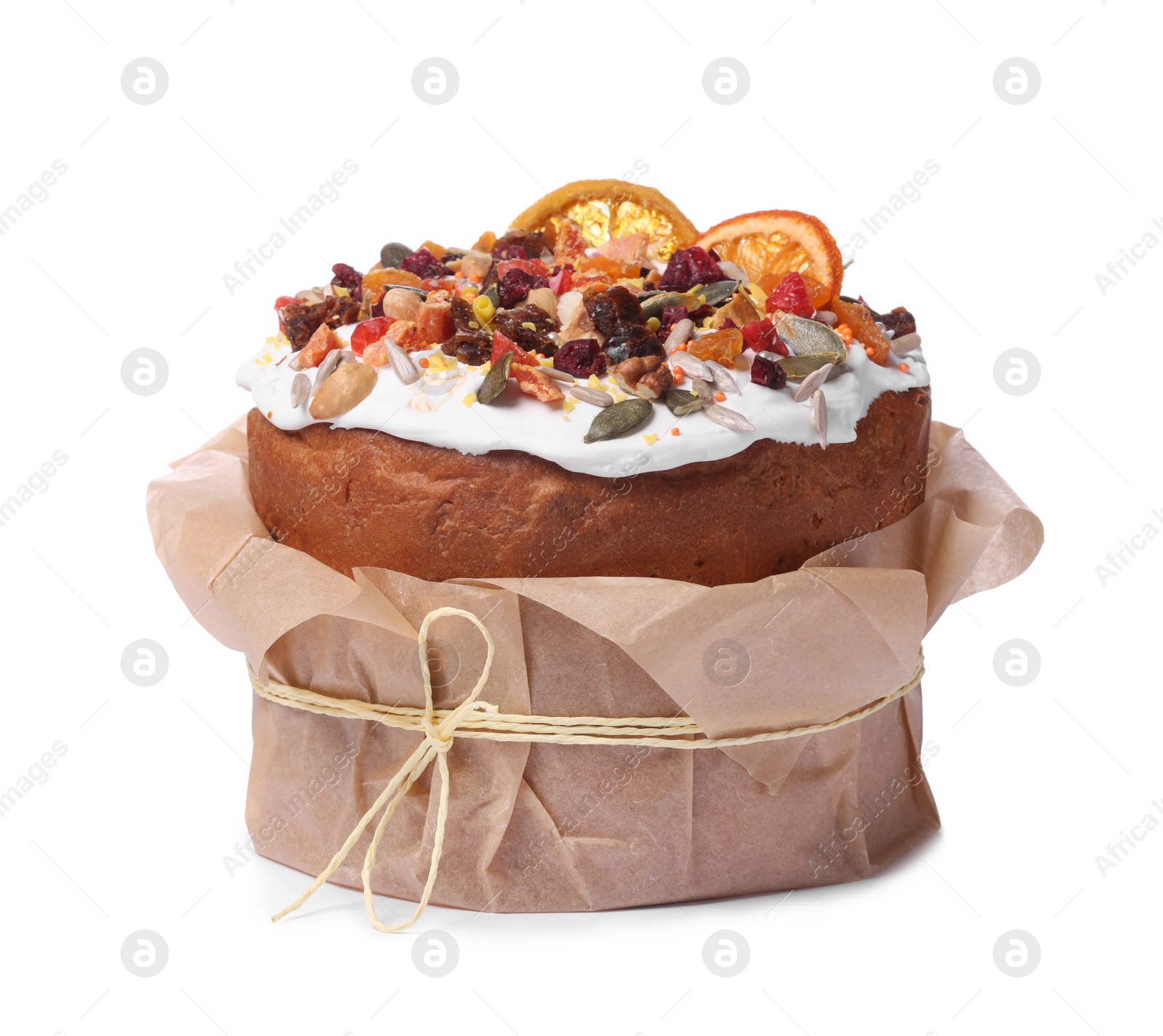 Photo of Traditional Easter cake with sprinkles and dried fruits in parchment paper isolated on white