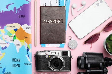Photo of Flat lay composition with passport, tickets and travel items on pink background