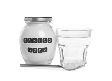 Photo of Jar and spoon with baking soda near glass of water on white background