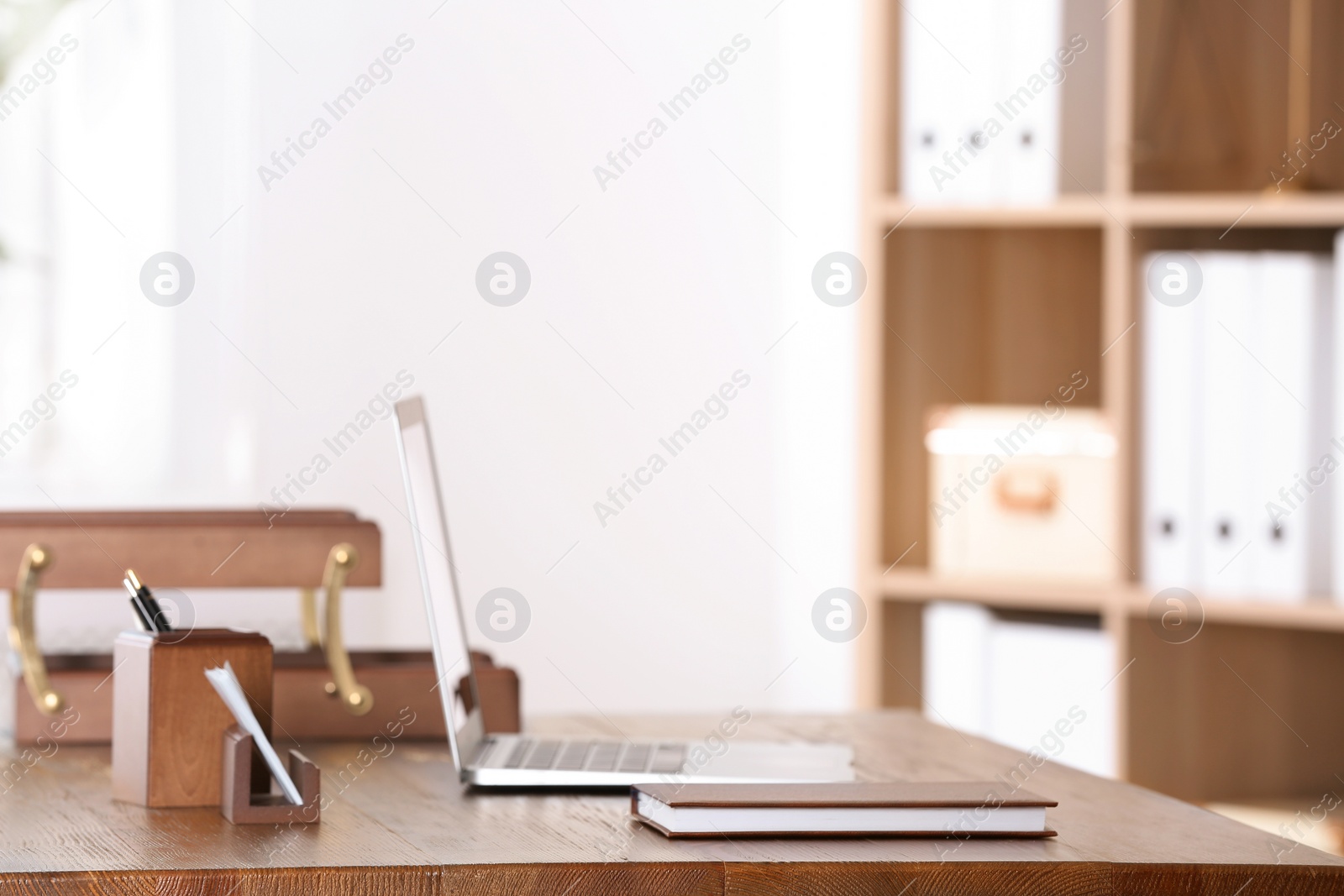 Photo of Table with laptop and stationery in lawyer's office