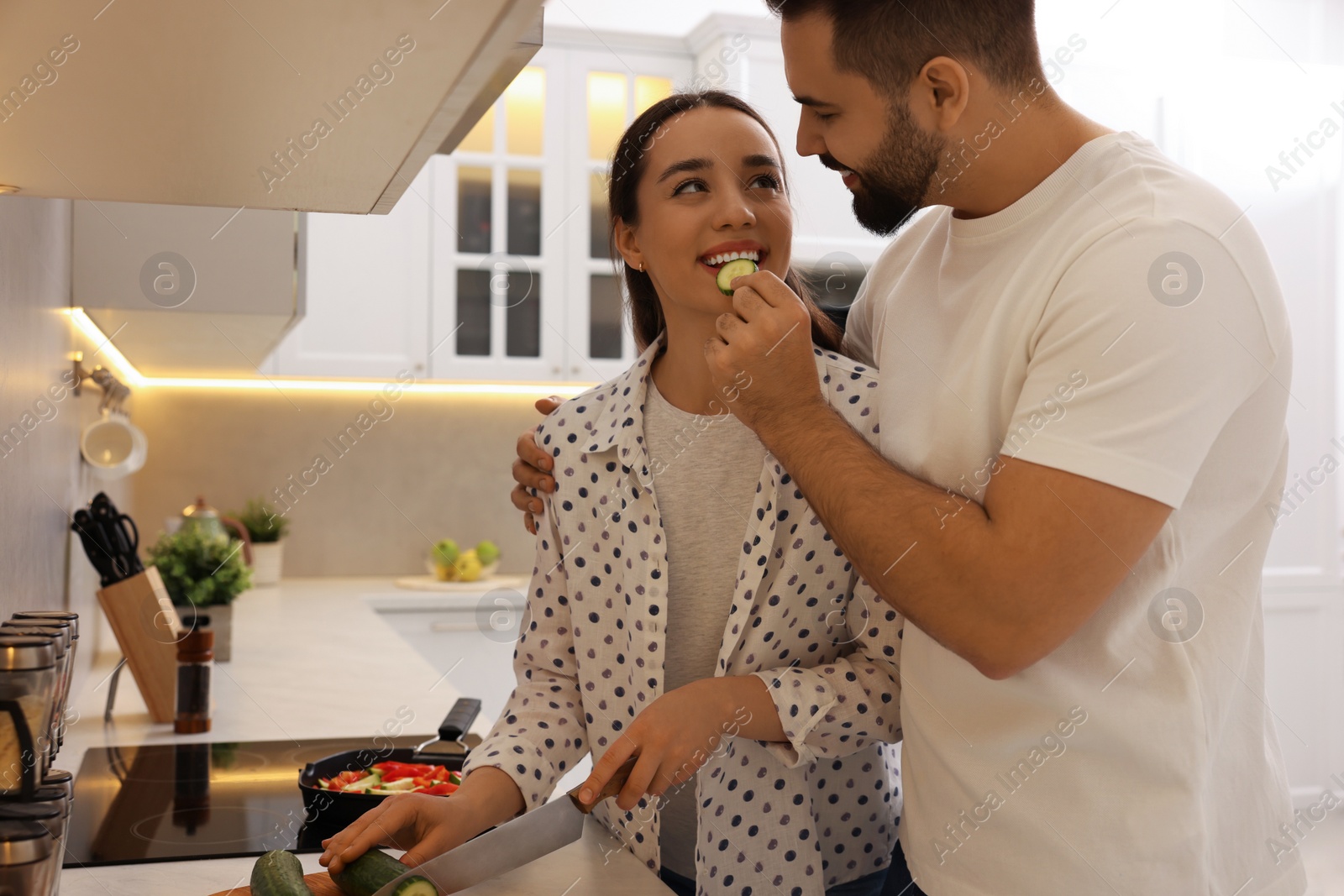 Photo of Happy lovely couple cooking together in kitchen