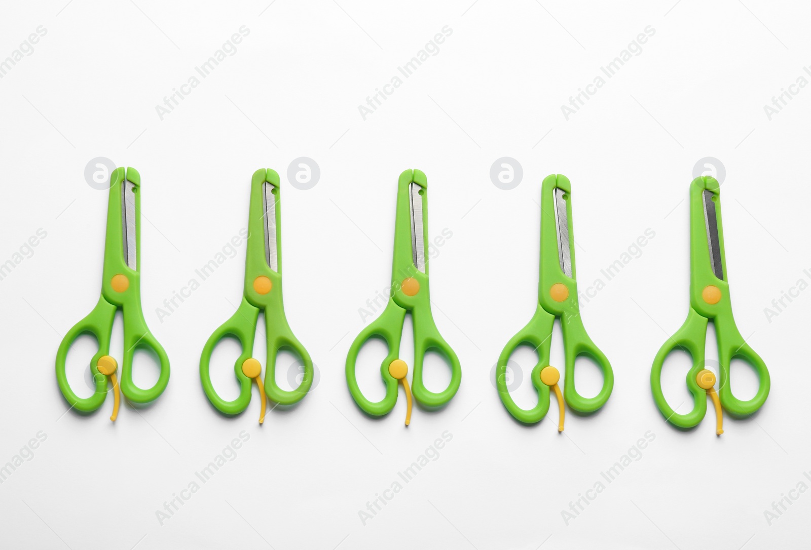 Photo of Set of training scissors on white background, top view