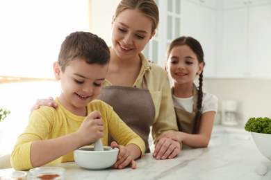 Photo of Happy family cooking together in kitchen at home