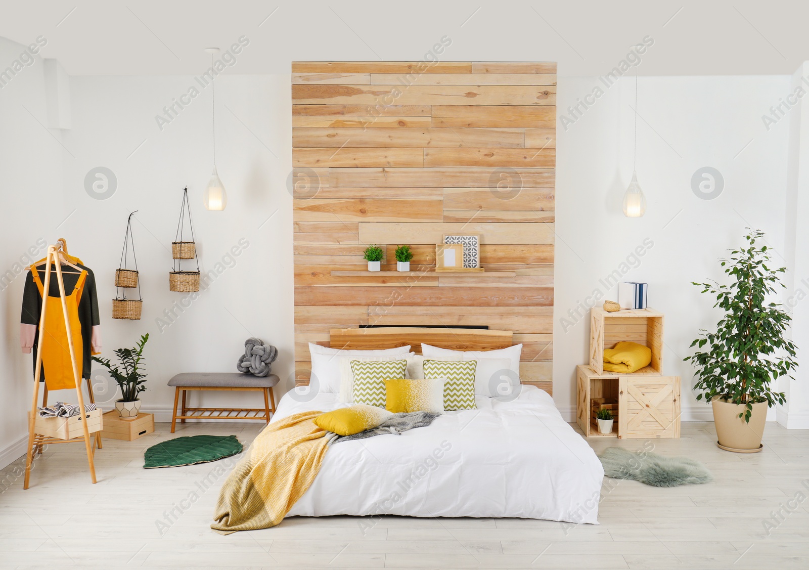 Photo of Stylish room interior with comfortable bed near wooden wall