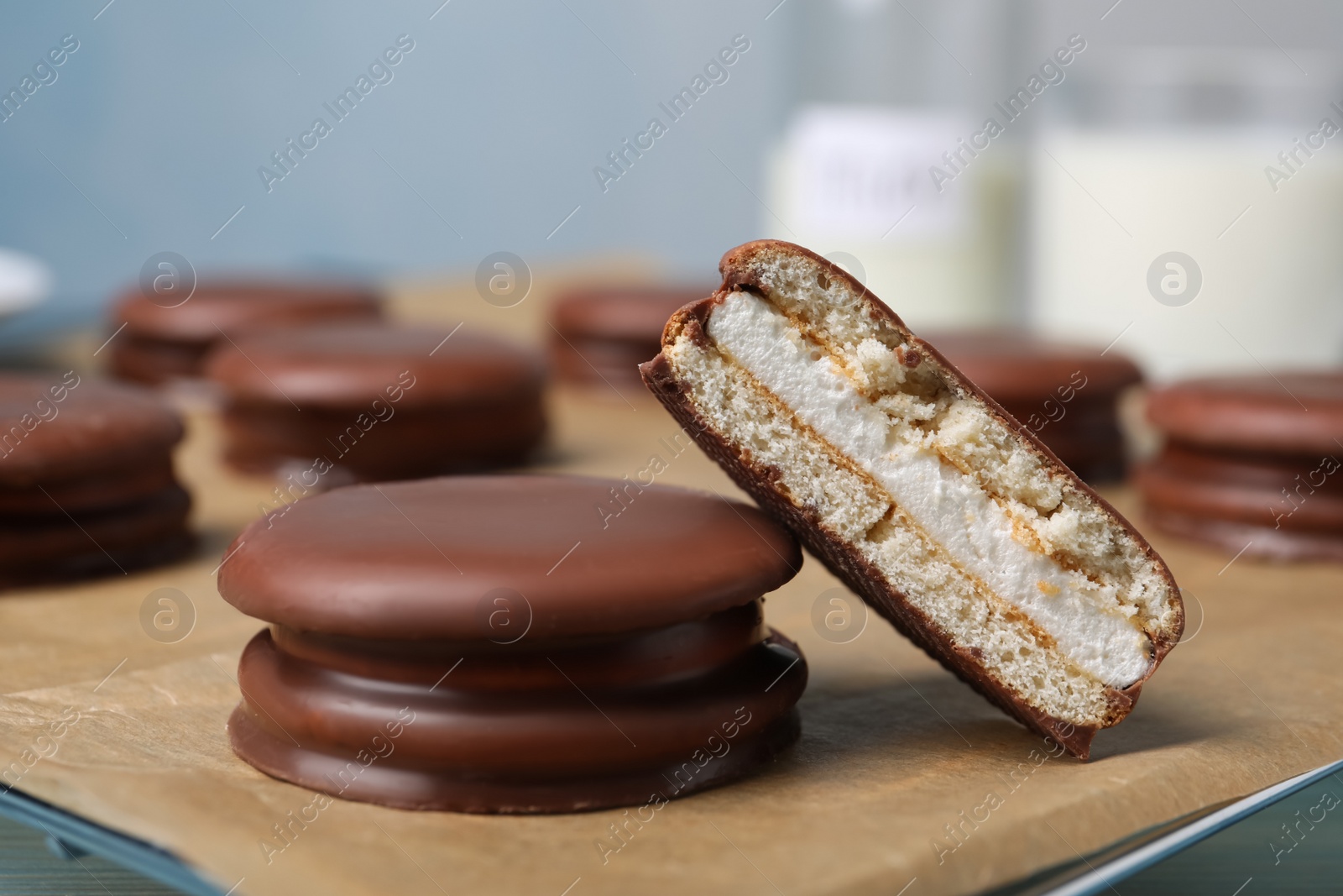 Photo of Tasty choco pies on parchment paper, closeup view