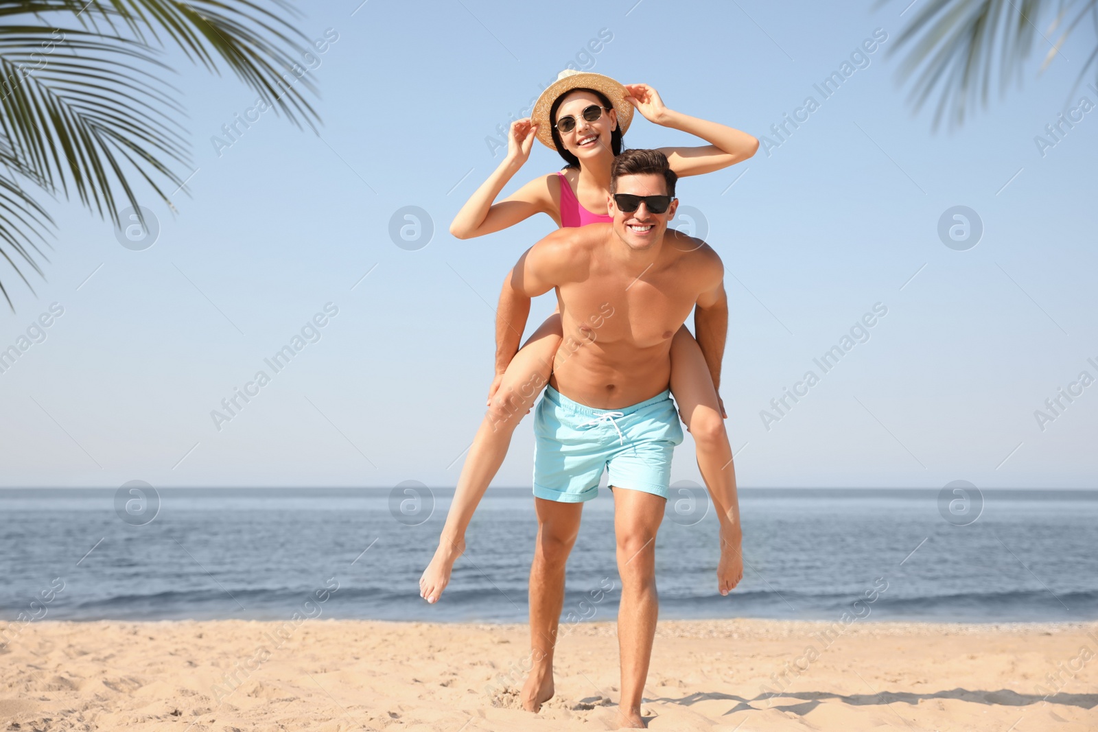 Photo of Happy couple having fun on sunny beach