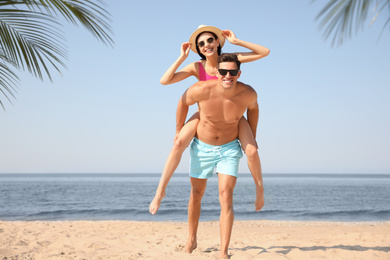 Happy couple having fun on sunny beach
