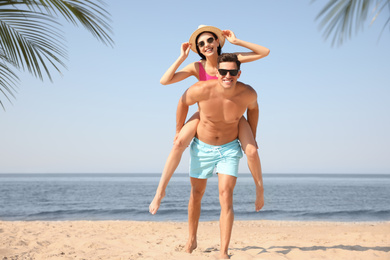 Photo of Happy couple having fun on sunny beach