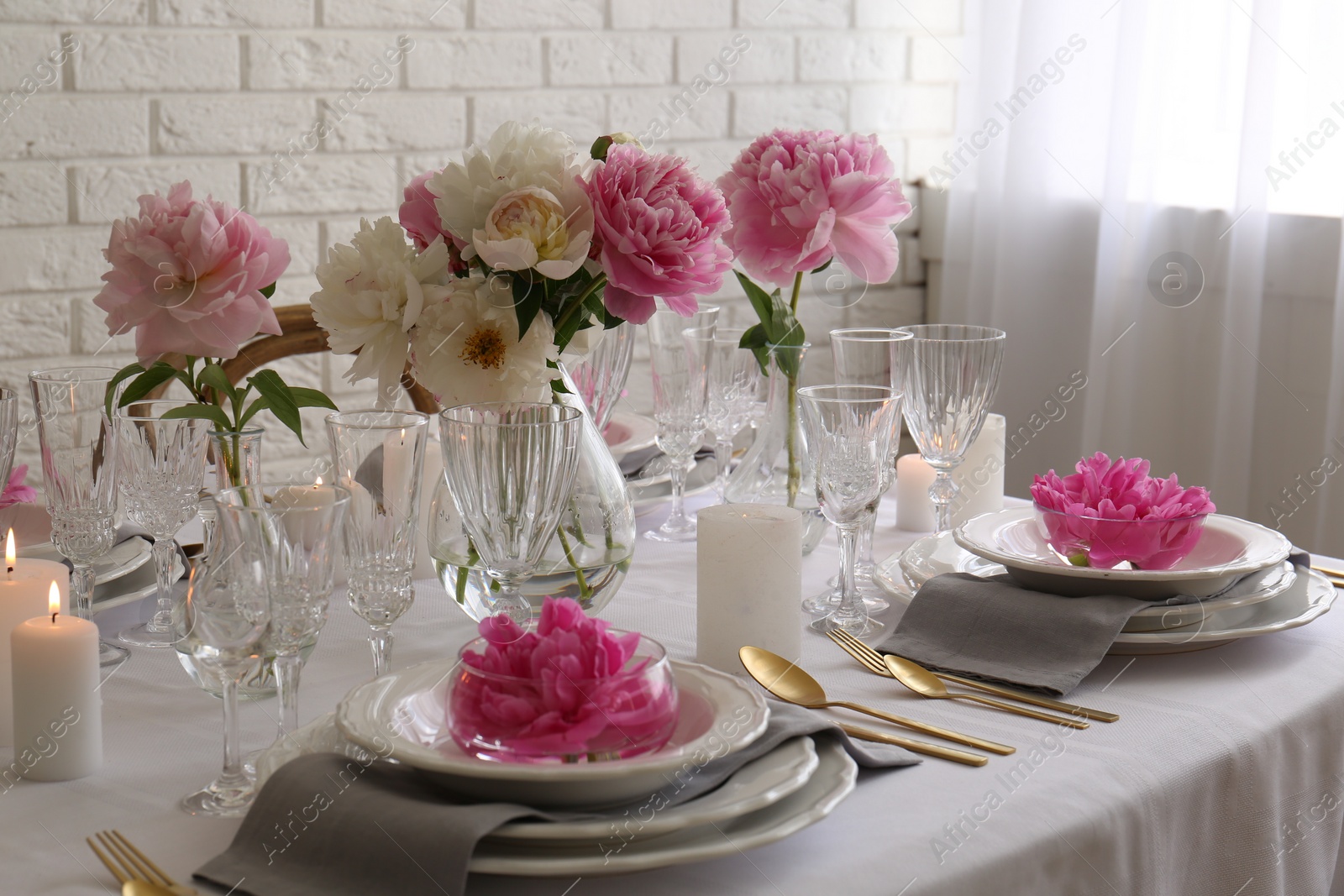 Photo of Stylish table setting with beautiful peonies in dining room