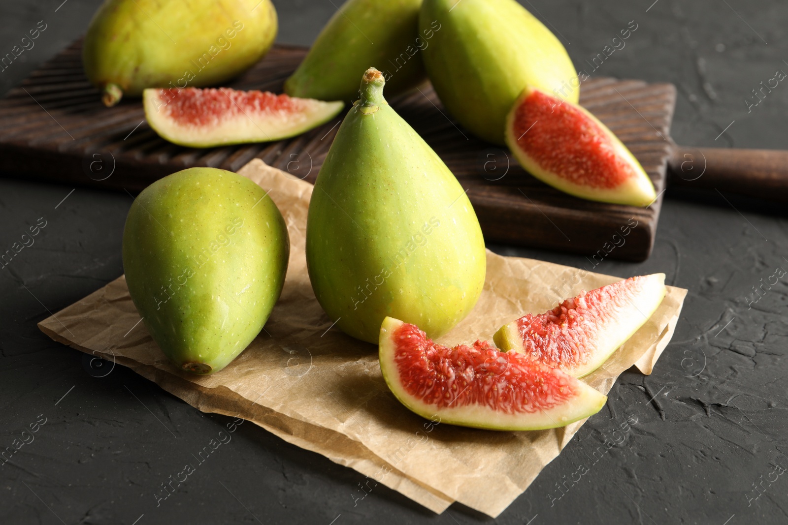 Photo of Fresh ripe figs on dark background. Tropical fruit