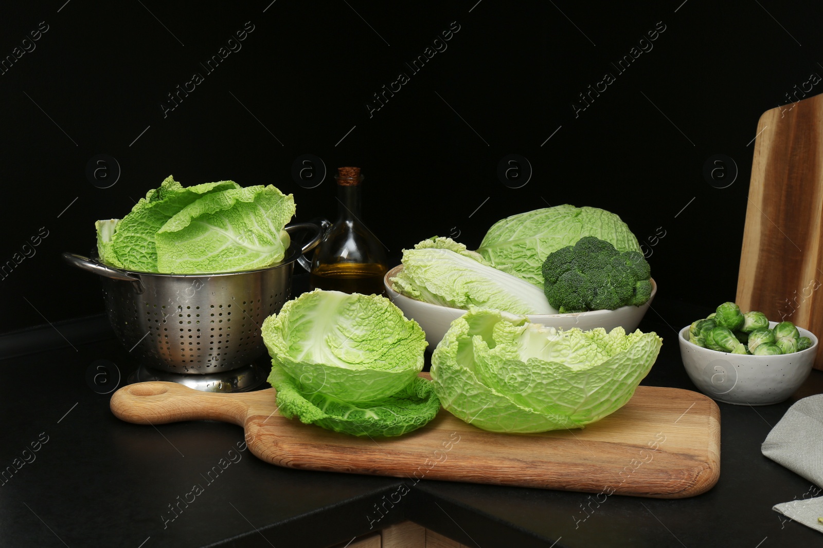 Photo of Different types of cabbage on countertop in kitchen