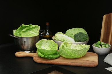 Different types of cabbage on countertop in kitchen