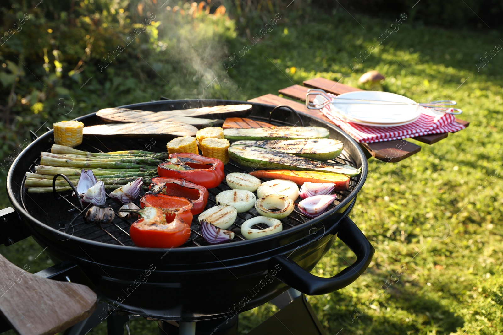 Photo of Delicious grilled vegetables on barbecue grill outdoors