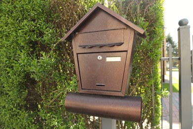 Photo of Black metal letter box on fence outdoors