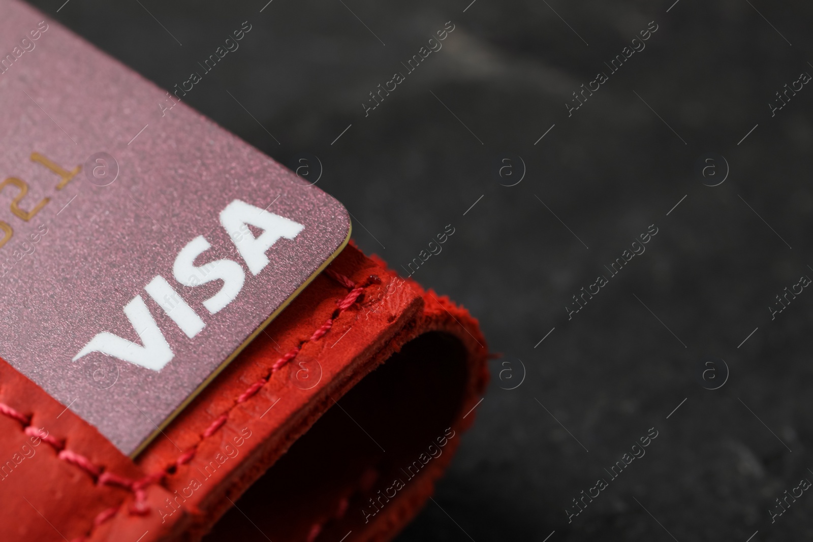 Photo of MYKOLAIV, UKRAINE - FEBRUARY 22, 2022: Wallet with Visa credit card on black table, closeup. Space for text