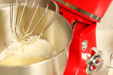 Photo of Modern mixer with raw dough indoors, closeup