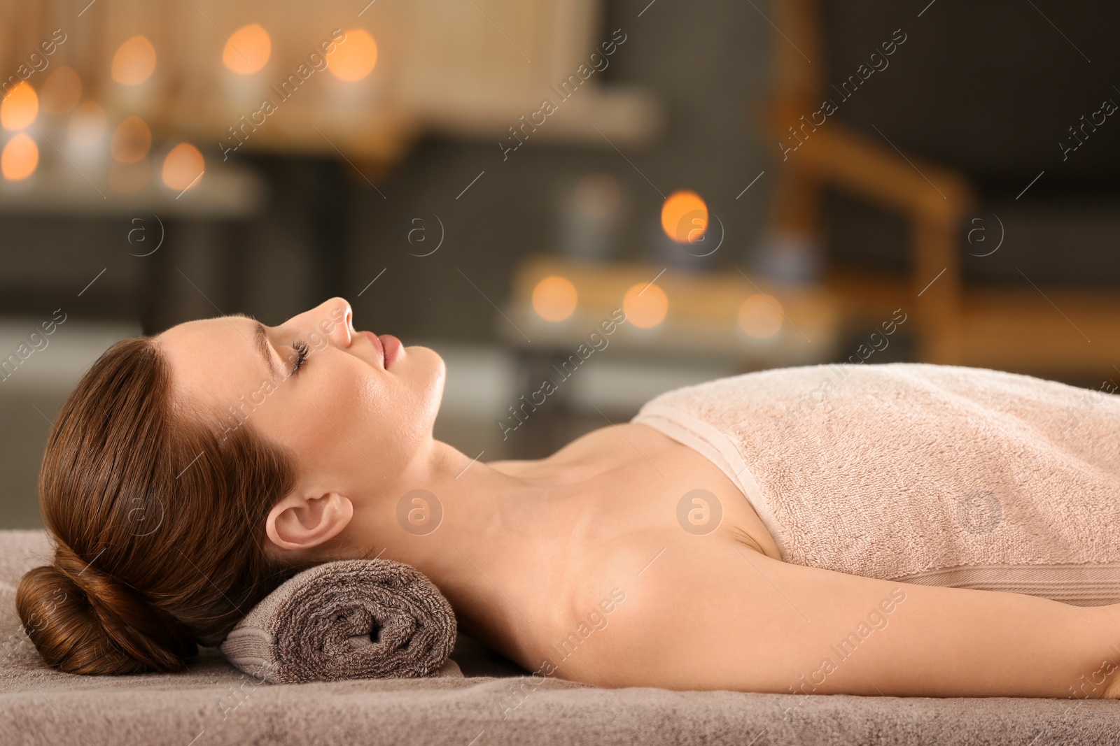 Photo of Beautiful young woman relaxing in spa salon