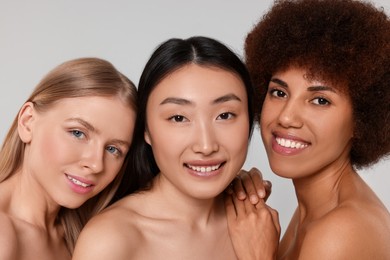 Portrait of beautiful young women on light grey background