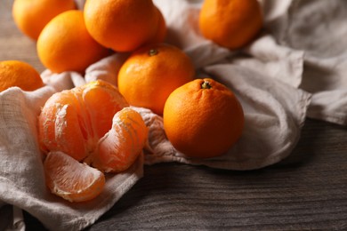 Photo of Many fresh ripe tangerines on wooden table, closeup