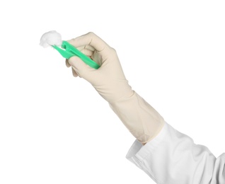 Doctor in medical glove holding disposable forceps with cotton ball on white background