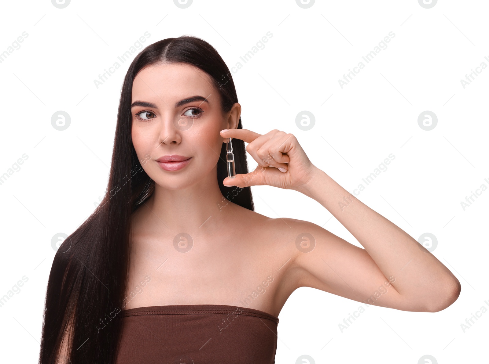 Photo of Beautiful young woman holding skincare ampoule on white background