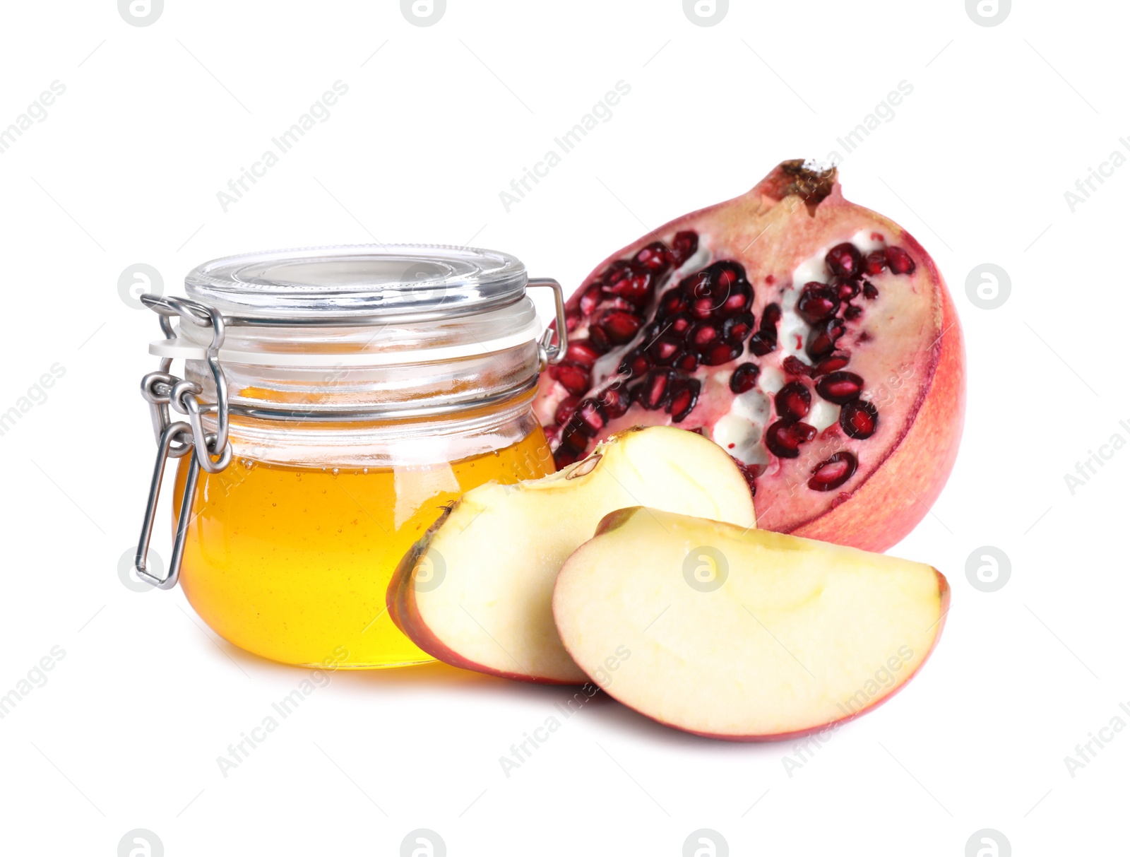 Photo of Honey, apple slices and pomegranate on white background. Rosh Hashanah holiday