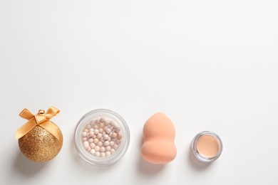 Photo of Flat lay composition with makeup products and Christmas decor on white background