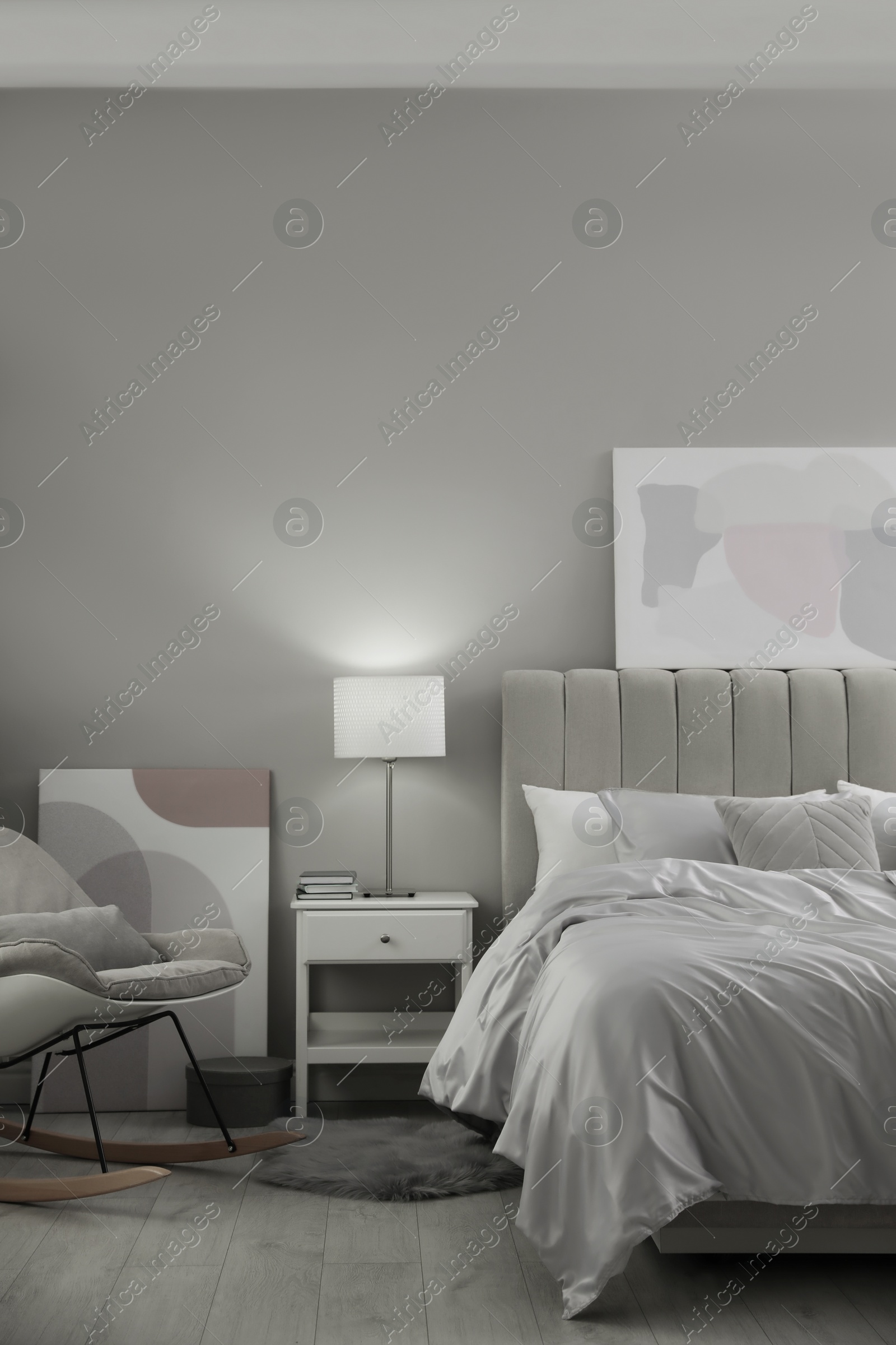 Photo of Cozy bed with soft silky bedclothes in light room